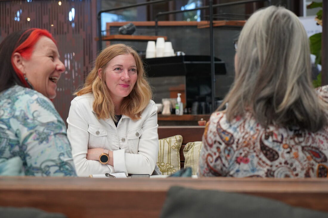 Women business owners in conversation at a HerBusiness event